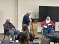 Steve Swain interviewing 2 elderly farmers in a large conference room at the IN AgrAbility - Huntington College AT Expo